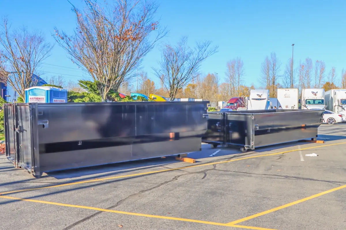 Professional dumpster rental service with roll-off container on residential driveway in Du Quoin